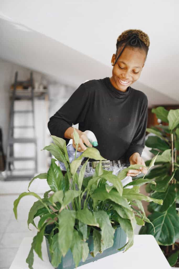 black girl watering plants 