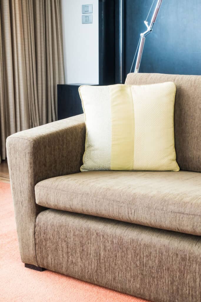 couch with yellow pillow